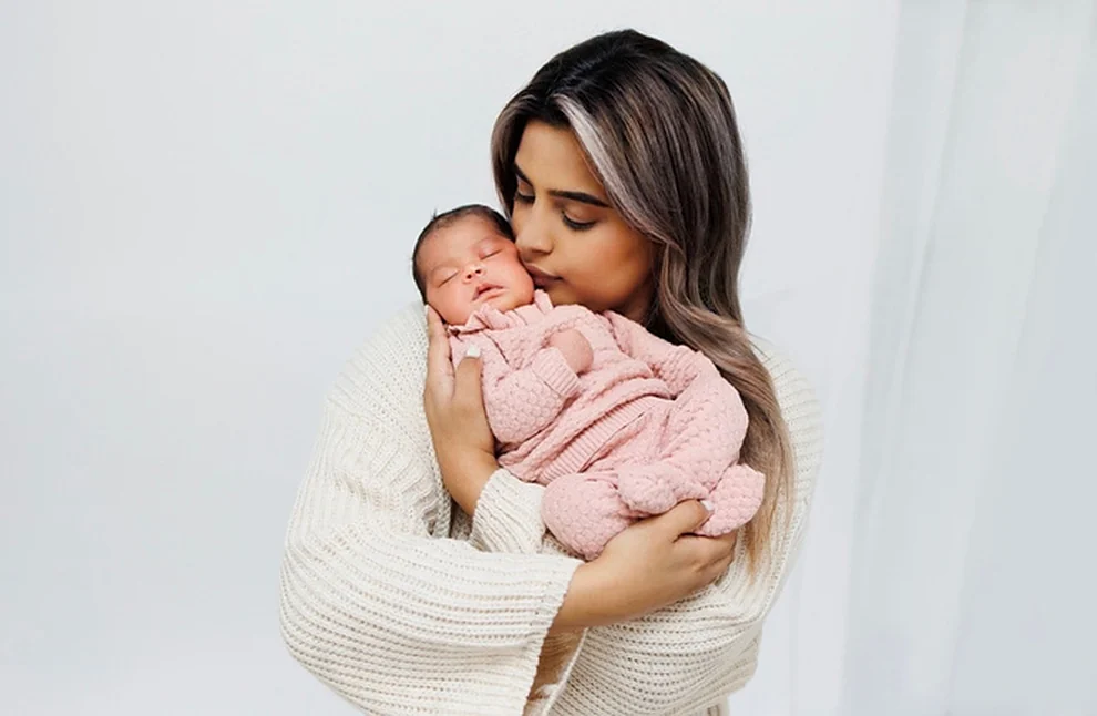Cheri cradling her newborn baby